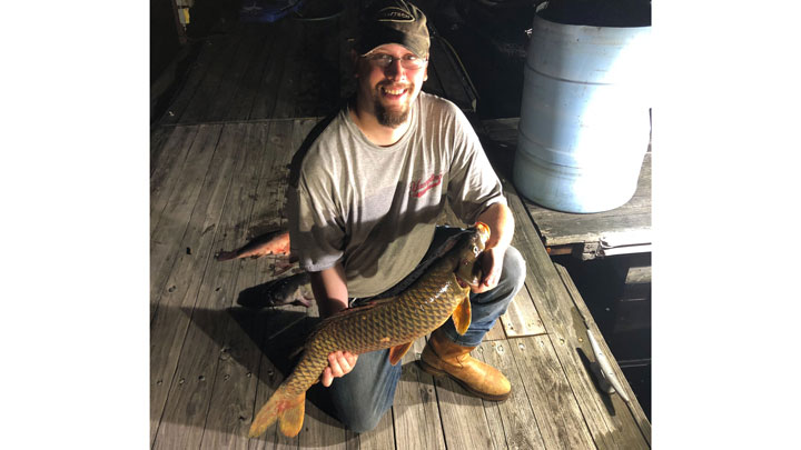 bowfisher holding fish