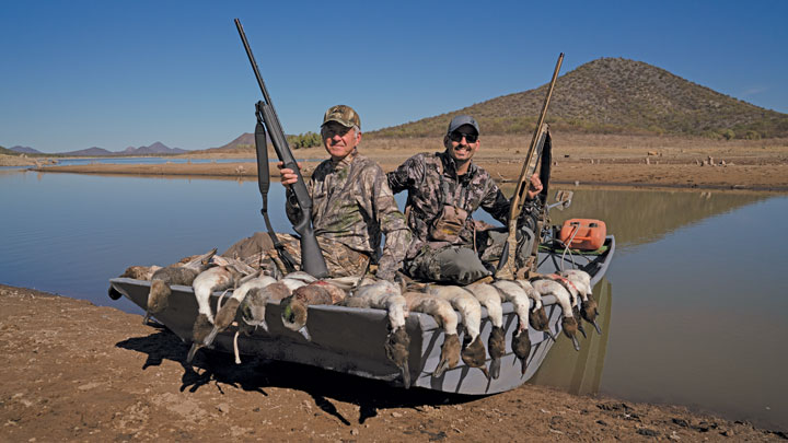 two hunters display pintail ducks taken while hunting