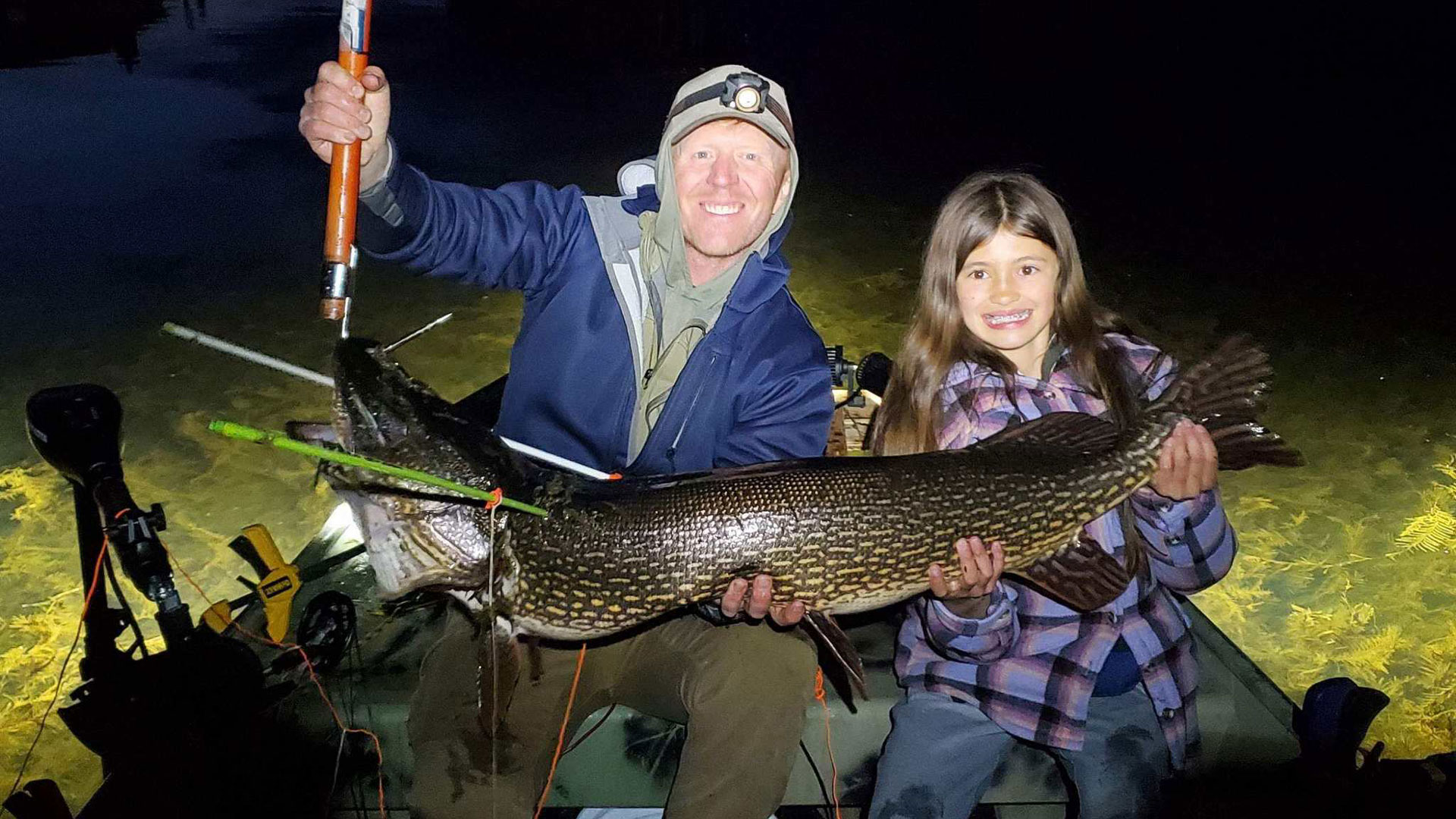 Lexi Dockstader with bow fishing world record pike fish. 