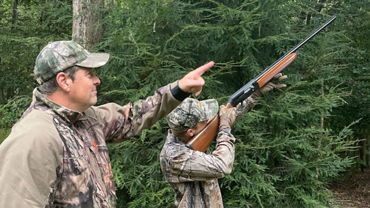 father introduces son to squirrel hunting