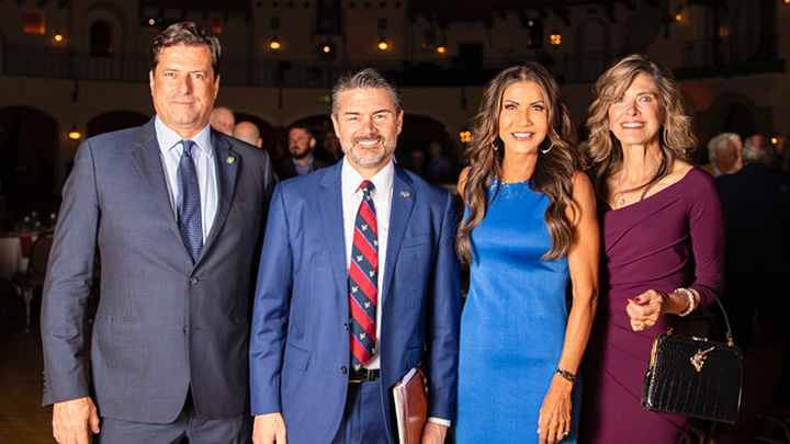 SD Gov. Kristi Noem, second from right, stands with NRA personnel at NRA HLF banquet