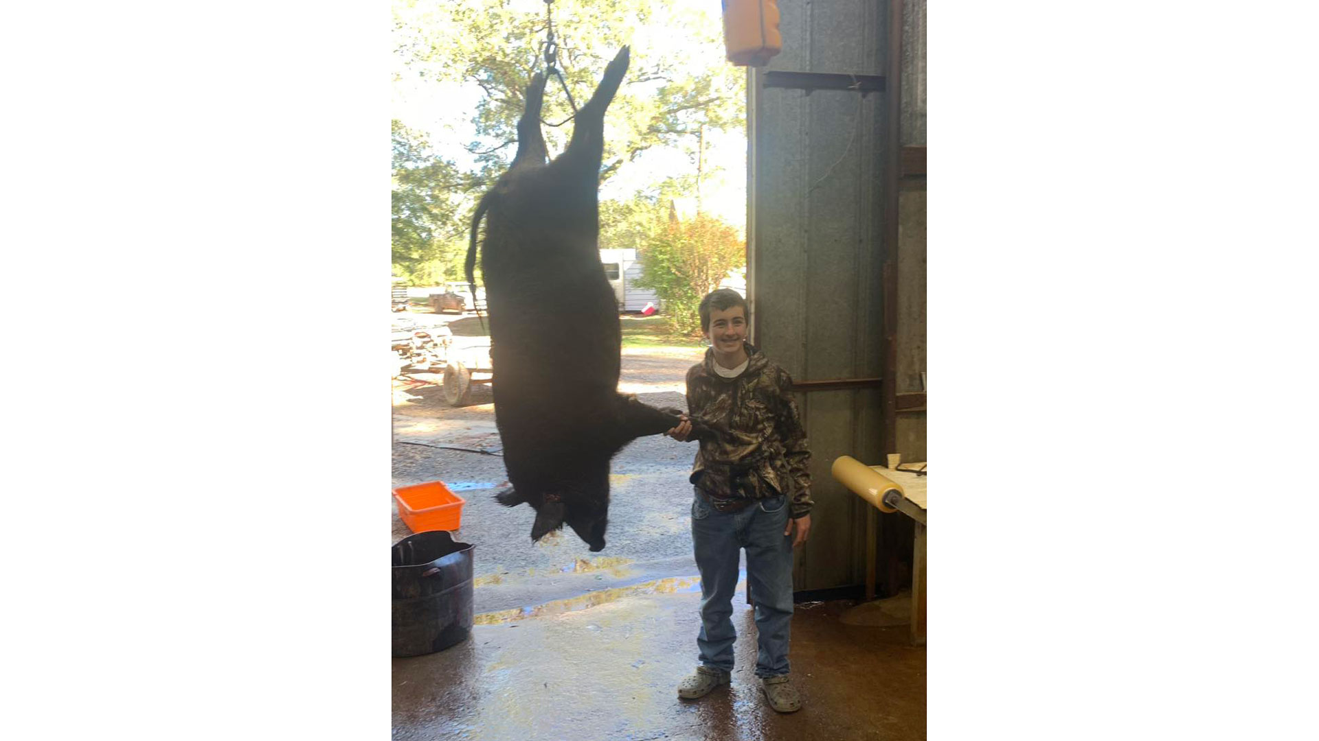 hunter with hog taken during hogapalooza