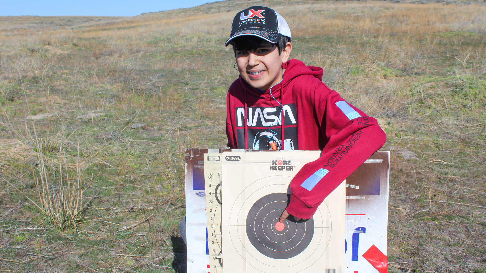 An airgun shooter collects targets after a shooting session.