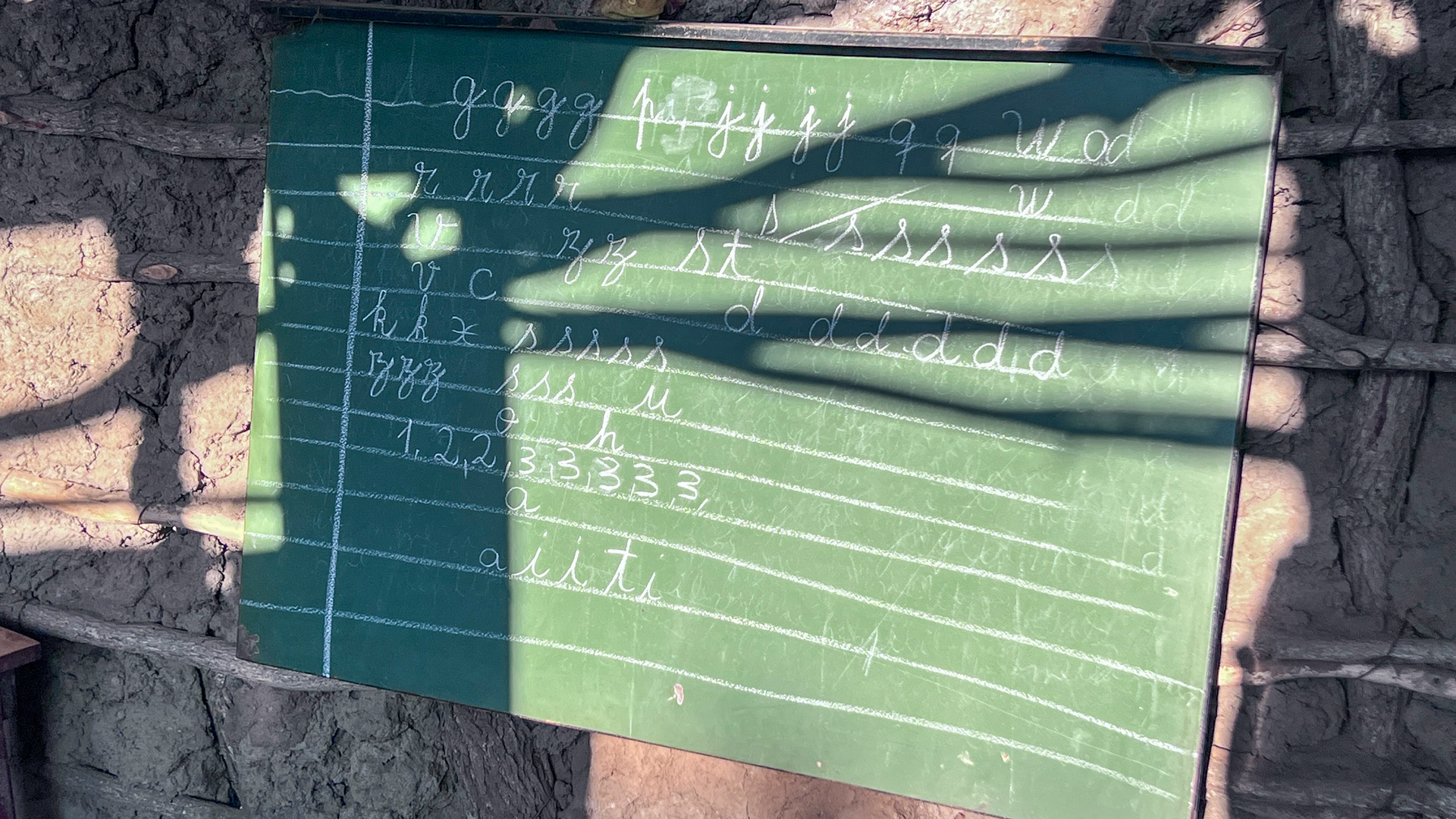 a blackboard hangs in the new school